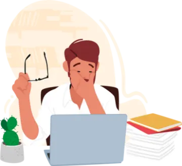 a person sitting at a desk with a laptop