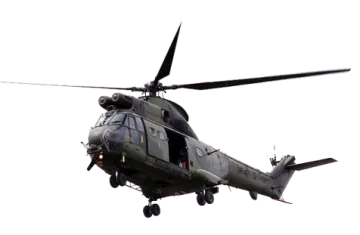 a military helicopter flying through the air