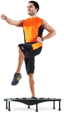 a man in an orange shirt is jumping on a skateboard