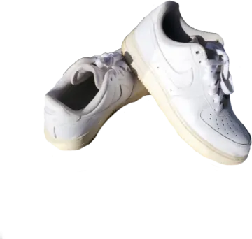 a pair of white sneakers on a white background