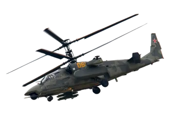 a military helicopter flying through the air