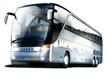 a white bus is driving down the road