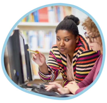 a woman sitting in front of a computer