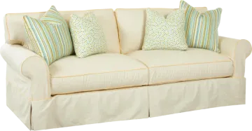 a white couch with blue and green pillows