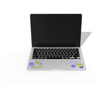 an open laptop computer on a white surface