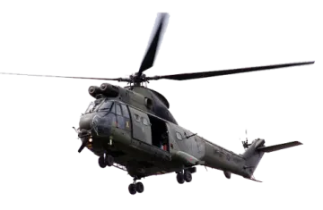 a military helicopter flying through the air