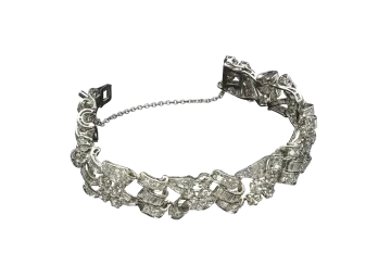 a silver bracelet with flowers and leaves