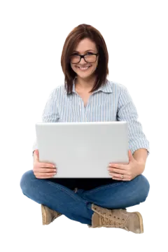 a woman sitting on the floor with her laptop
