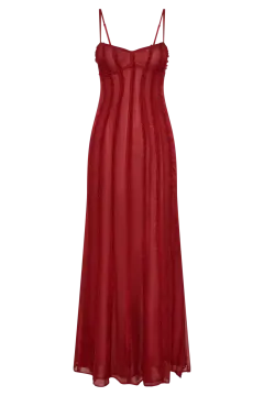 a woman wearing a red dress with spaghetti straps