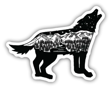 a black and white wolf with mountains in the background