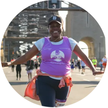 a woman in a purple shirt is running