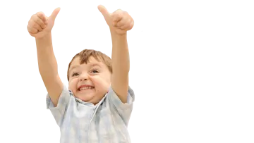 a young boy raising his hands in the air