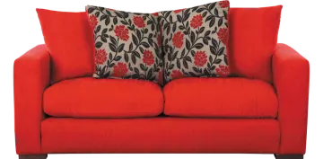 a red couch with two pillows on it