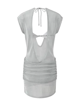 a woman wearing a silver top with a tie around the neck