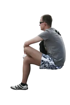 a man sitting on the ground with his legs crossed