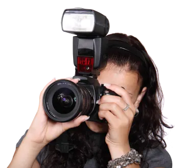 a woman holding a camera up to her face