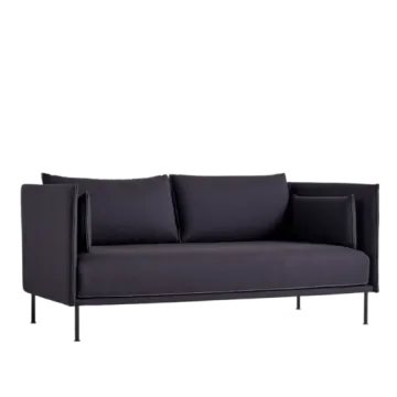 a black sofa with two pillows on it