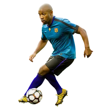 a man in a blue shirt kicking a soccer ball