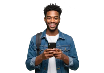 a young man in a denim jacket is smiling and looking at his phone