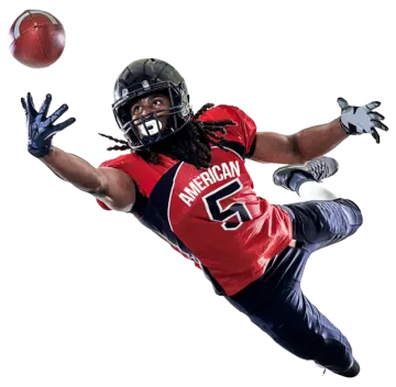 a football player in the air catching a ball