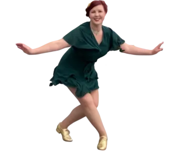 a young girl in a green dress is dancing