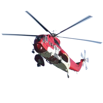 a red and white helicopter flying in the sky