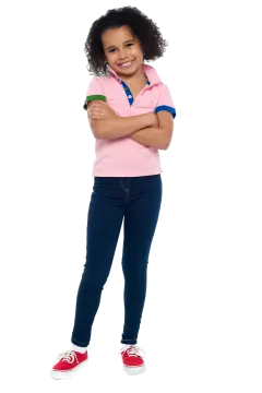 a little girl standing with her arms crossed