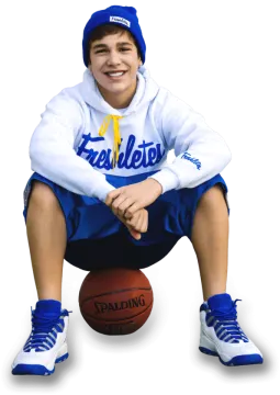 a young boy sitting on a basketball ball