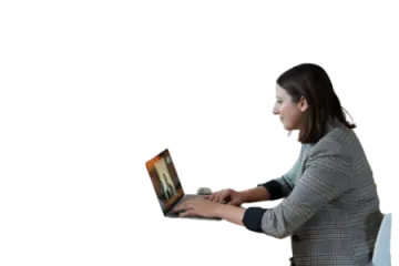 a woman sitting on a chair using a laptop