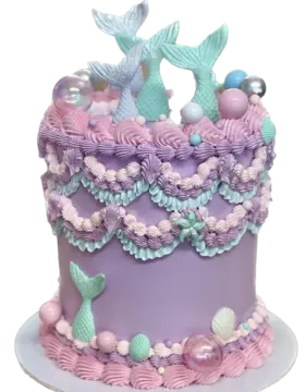 a purple and blue cake with mermaids on top