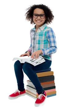 a little girl sitting on top of a pile of books
