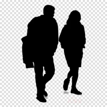 a silhouette of two people walking down the street