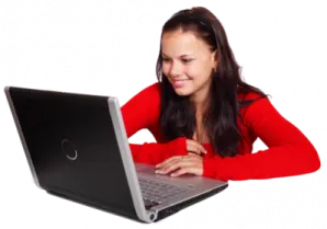 a woman sitting at a table with a laptop
