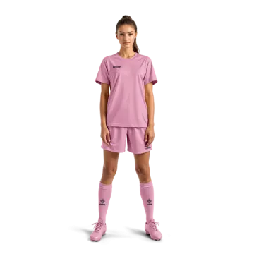 a young girl in pink soccer jersey and shorts