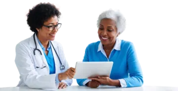 two female doctors looking at a tablet