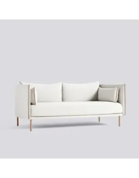 a white couch with two pillows on it