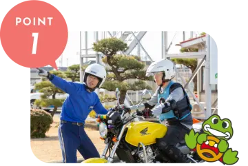 two people on a motorcycle in front of a building