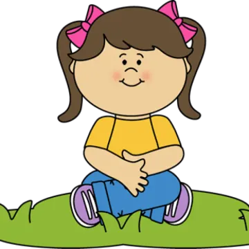 a little girl sitting on the grass