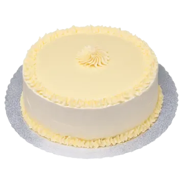 a white cake with yellow frosting on top