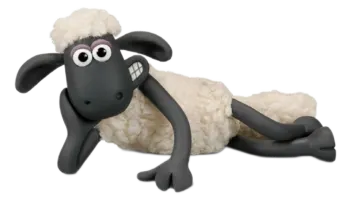 a stuffed sheep laying down on the ground