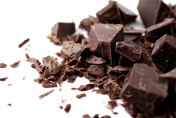 a pile of chocolate on a white surface