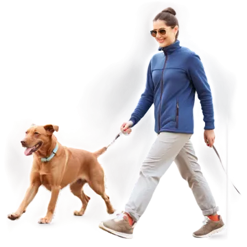 a woman walking a dog on a leash
