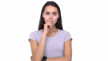 a woman holding her finger to her mouth