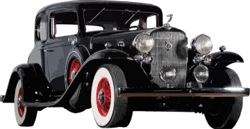 an old black car with red rims