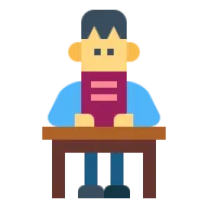 a person sitting at a desk with a book