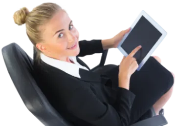 a woman sitting in an office chair holding a tablet