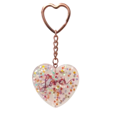 a heart shaped keychai with the word love written on it