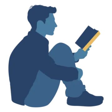 a man sitting on the ground reading a book