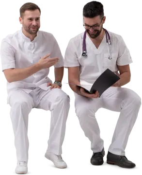 two male doctors sitting on a white surface