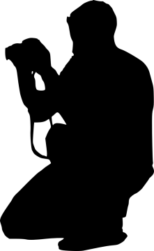a silhouette of a man kneeling with his dog